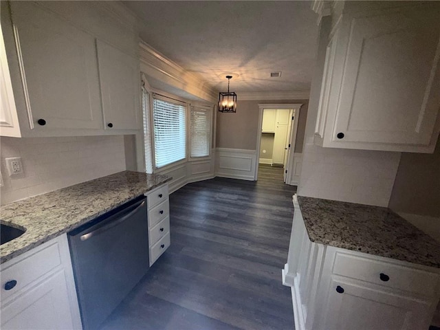 kitchen with dishwashing machine, white cabinets, crown molding, and wainscoting