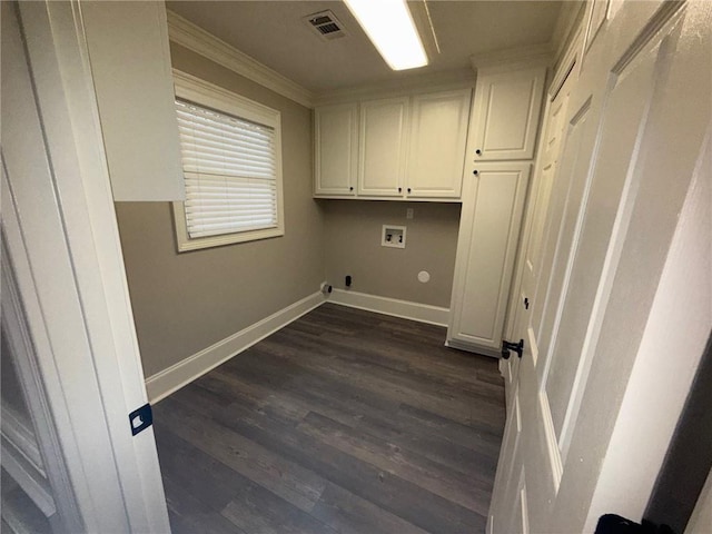 clothes washing area with washer hookup, visible vents, cabinet space, and baseboards