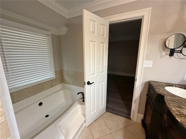 bathroom with vanity, baseboards, tile patterned flooring, crown molding, and a bath