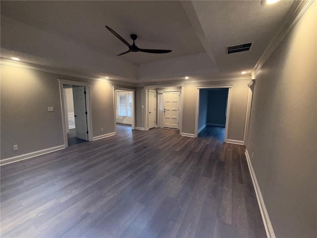 unfurnished room with baseboards, visible vents, dark wood finished floors, ceiling fan, and crown molding