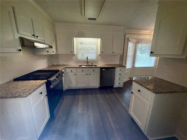 kitchen featuring under cabinet range hood, gas range, dishwasher, white cabinets, and a sink