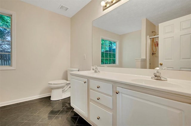 5410 Lenox Park Pl, Buford, GA 30518 - full bathroom with double vanity, a shower with shower door, tile patterned flooring, toilet, and baseboards