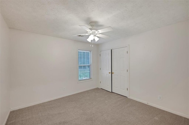 5410 Lenox Park Pl, Buford, GA 30518 - unfurnished room featuring light carpet, ceiling fan, baseboards, and a textured ceiling