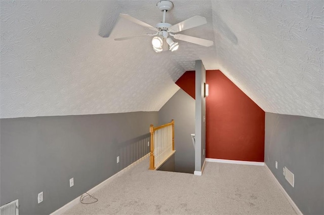 5410 Lenox Park Pl, Buford, GA 30518 - bonus room featuring a textured ceiling, lofted ceiling, carpet, ceiling fan, and baseboards