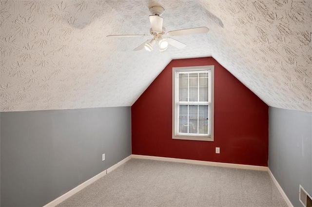 5410 Lenox Park Pl, Buford, GA 30518 - bonus room with a textured ceiling, ceiling fan, baseboards, lofted ceiling, and carpet flooring
