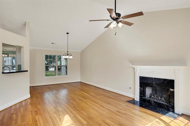5410 Lenox Park Pl, Buford, GA 30518 - unfurnished living room featuring a chandelier, wood finished floors, ceiling fan, crown molding, and baseboards