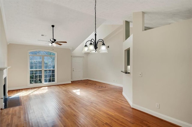 5410 Lenox Park Pl, Buford, GA 30518 - unfurnished dining area featuring lofted ceiling, a ceiling fan, a textured ceiling, baseboards, and wood finished floors
