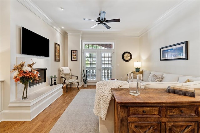 77 Peachtree Pl NE Unit 101, Atlanta, GA 30309 - living room with light wood finished floors, a ceiling fan, and crown molding