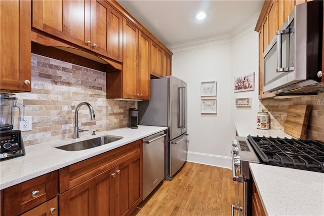 77 Peachtree Pl NE Unit 101, Atlanta, GA 30309 - kitchen featuring appliances with stainless steel finishes, crown molding, backsplash, light wood-type flooring, and brown cabinets