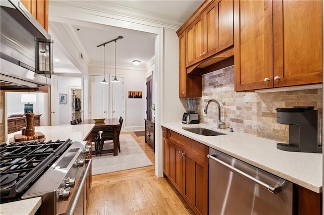 77 Peachtree Pl NE Unit 101, Atlanta, GA 30309 - kitchen with stainless steel appliances, ornamental molding, light wood-type flooring, brown cabinetry, and backsplash