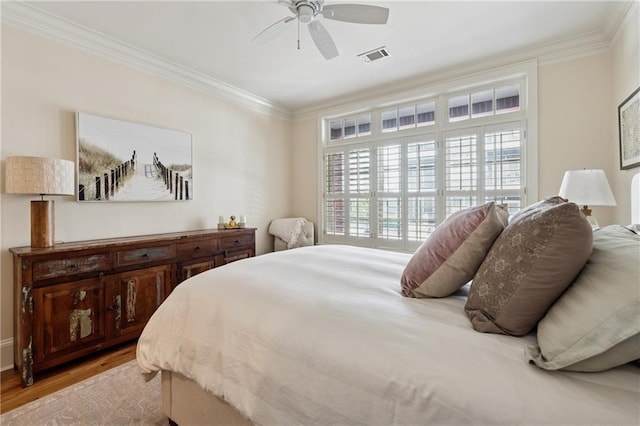 77 Peachtree Pl NE Unit 101, Atlanta, GA 30309 - bedroom featuring ornamental molding, wood finished floors, and a ceiling fan