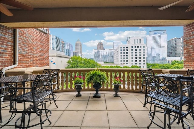 77 Peachtree Pl NE Unit 101, Atlanta, GA 30309 - balcony with a view of skyline, ceiling fan, and outdoor dining space