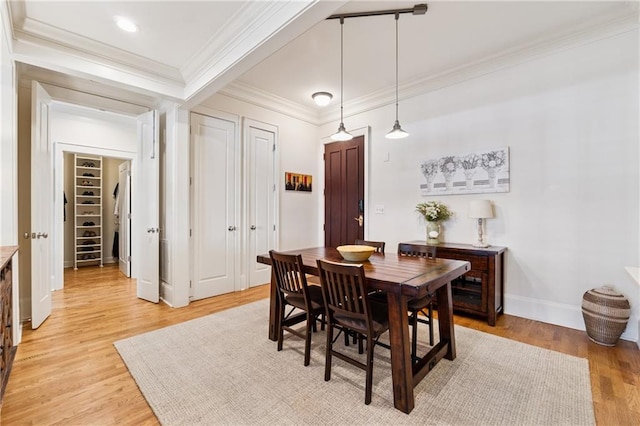 77 Peachtree Pl NE Unit 101, Atlanta, GA 30309 - dining area featuring crown molding and light wood-type flooring