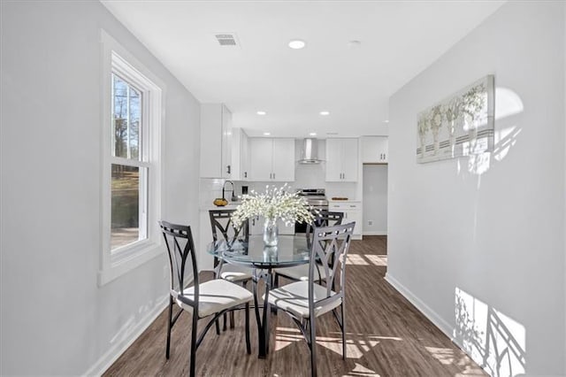 dining area with sink and dark hardwood / wood-style floors