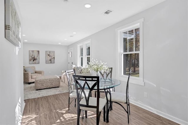 dining space with hardwood / wood-style flooring