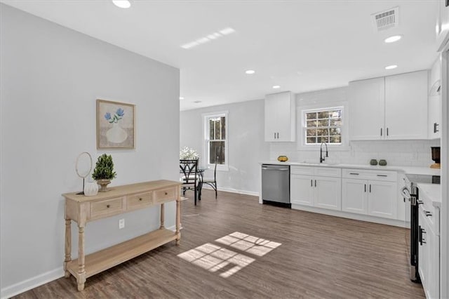 kitchen with dark hardwood / wood-style flooring, white cabinets, a healthy amount of sunlight, and appliances with stainless steel finishes