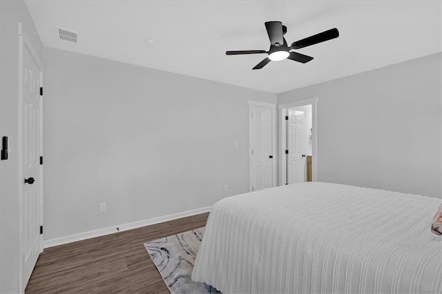 bedroom with ceiling fan and dark hardwood / wood-style floors