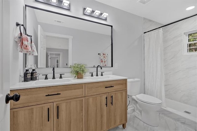 bathroom featuring a shower with shower curtain, vanity, and toilet