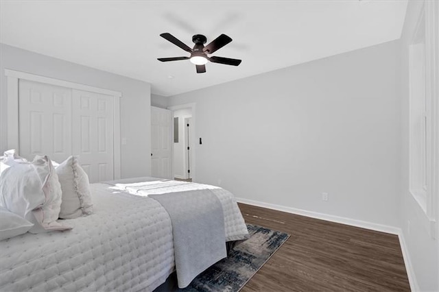 bedroom with ceiling fan, dark hardwood / wood-style flooring, and a closet