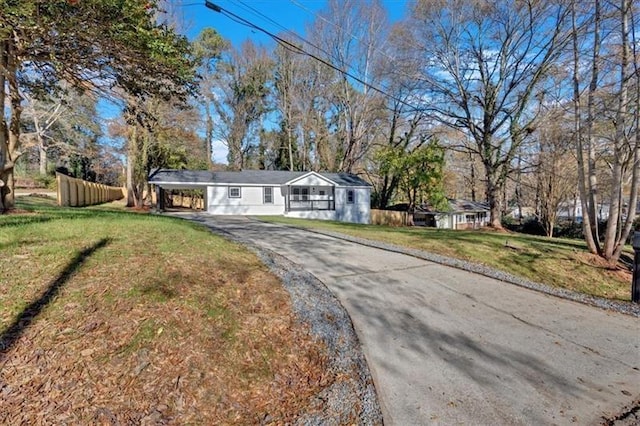 ranch-style home with a carport and a front lawn