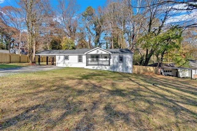 ranch-style house with a carport and a front lawn