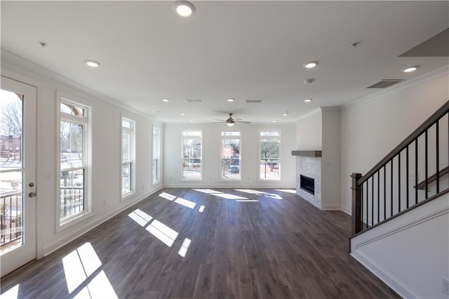 unfurnished living room featuring visible vents, baseboards, crown molding, and a fireplace