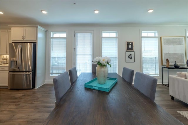 dining area featuring ornamental molding, dark wood-type flooring, and recessed lighting