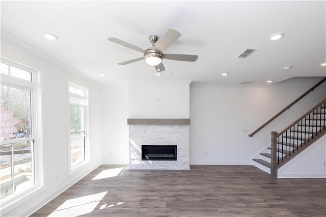 unfurnished living room featuring ceiling fan, visible vents, a fireplace, stairway, and recessed lighting
