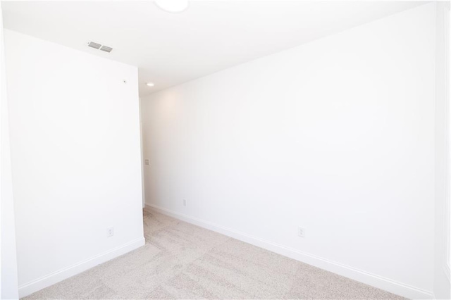 unfurnished room with baseboards, light carpet, recessed lighting, and visible vents