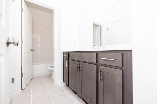 bathroom featuring toilet, shower / washtub combination, tile patterned flooring, and vanity