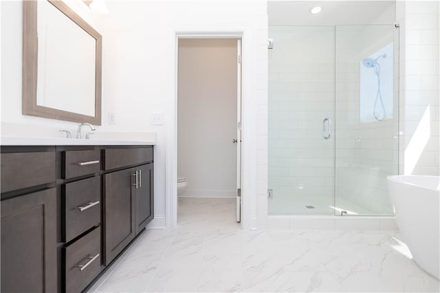 bathroom featuring vanity, recessed lighting, a stall shower, and toilet