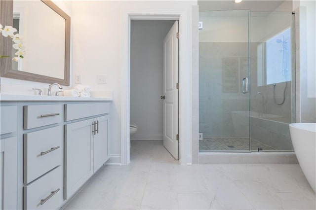 bathroom featuring a stall shower, a soaking tub, vanity, and toilet