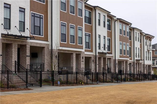 view of property featuring a residential view and fence