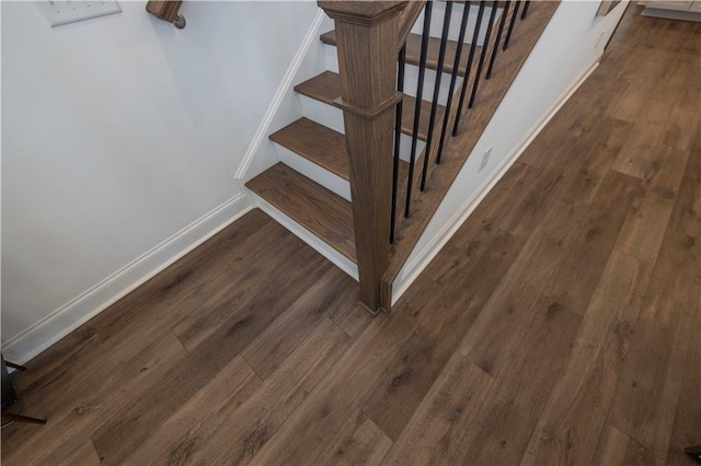 stairs with baseboards and wood finished floors