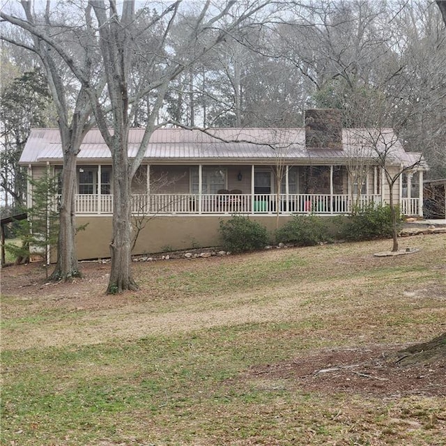 582 S Cherokee Rd, Social Circle, GA 30025 - view of front of property featuring a porch, metal roof, a front yard, and a chimney