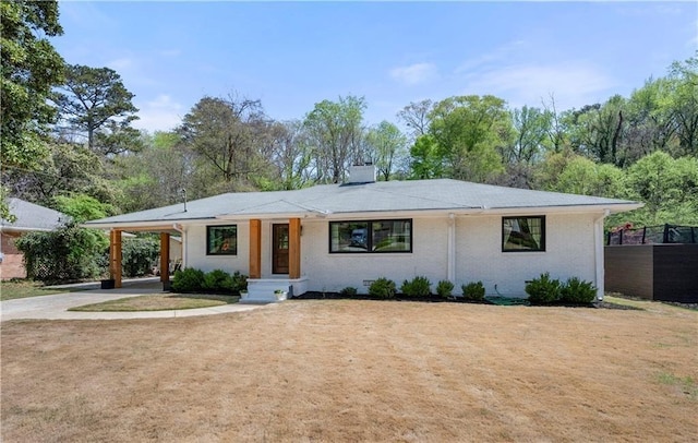 4237 Rickenbacker Way NE, Atlanta, GA 30342 - view of front of property featuring concrete driveway, a chimney, and a carport