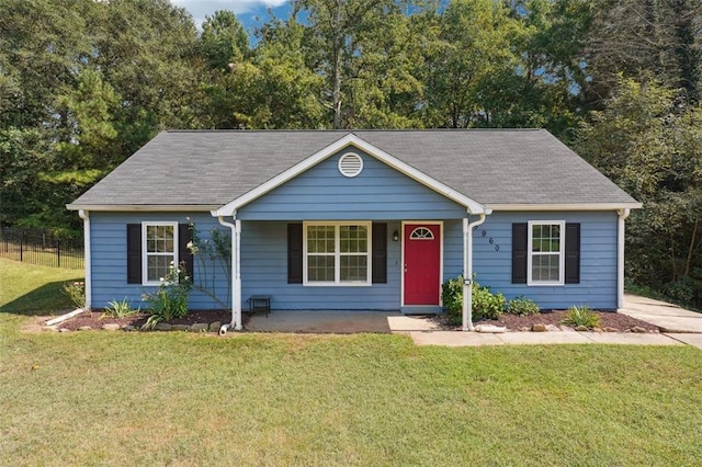 ranch-style house with covered porch and a front yard