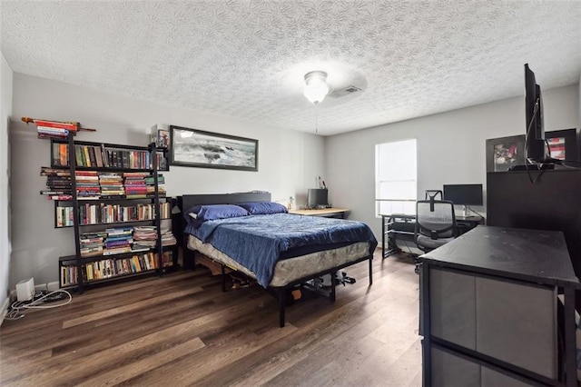 bedroom featuring a textured ceiling and hardwood / wood-style floors