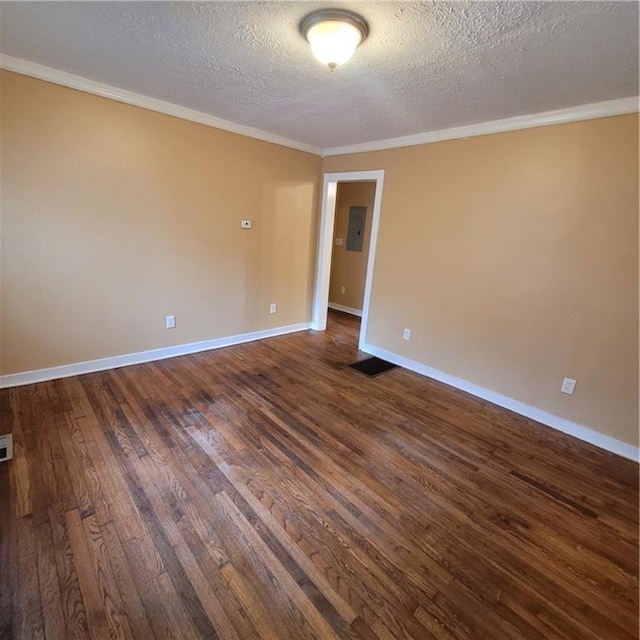 spare room featuring baseboards, a textured ceiling, dark wood-style flooring, and crown molding