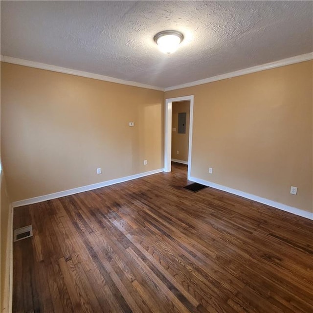 unfurnished room featuring baseboards, dark wood-style floors, visible vents, and ornamental molding