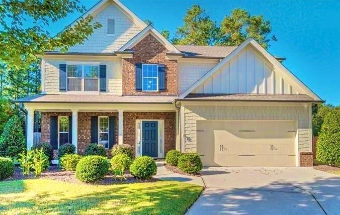 craftsman-style home featuring a garage and a front yard