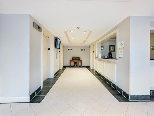 2479 Peachtree Rd NE Unit 407, Atlanta, GA 30305 - hallway featuring recessed lighting, tile patterned flooring, a raised ceiling, and baseboards