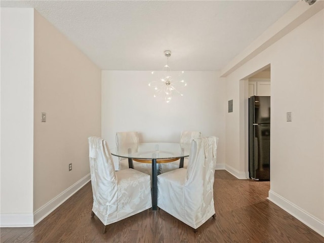 2479 Peachtree Rd NE Unit 407, Atlanta, GA 30305 - dining room with a chandelier, wood finished floors, and baseboards