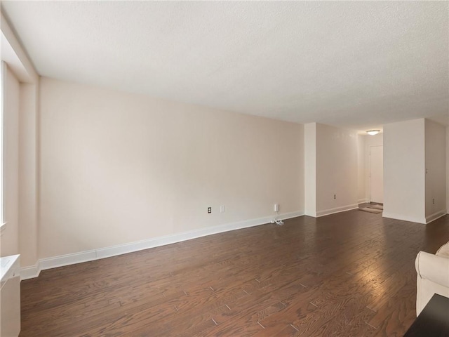2479 Peachtree Rd NE Unit 407, Atlanta, GA 30305 - unfurnished living room with dark wood-style floors, baseboards, and a textured ceiling