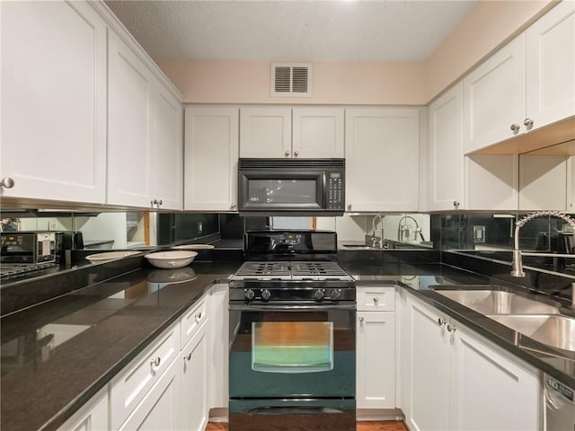2479 Peachtree Rd NE Unit 407, Atlanta, GA 30305 - kitchen featuring black appliances, a sink, white cabinetry, dark stone countertops, and backsplash