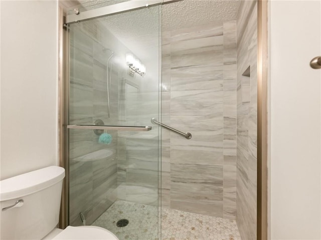 2479 Peachtree Rd NE Unit 407, Atlanta, GA 30305 - bathroom with toilet, a stall shower, and a textured ceiling