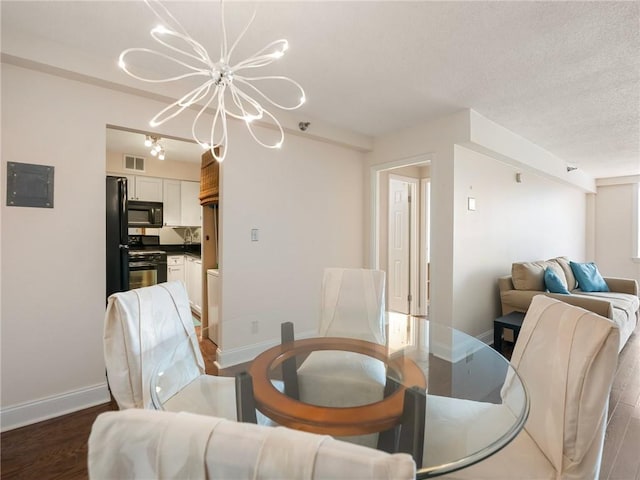 2479 Peachtree Rd NE Unit 407, Atlanta, GA 30305 - dining space with a chandelier, baseboards, wood finished floors, electric panel, and a textured ceiling