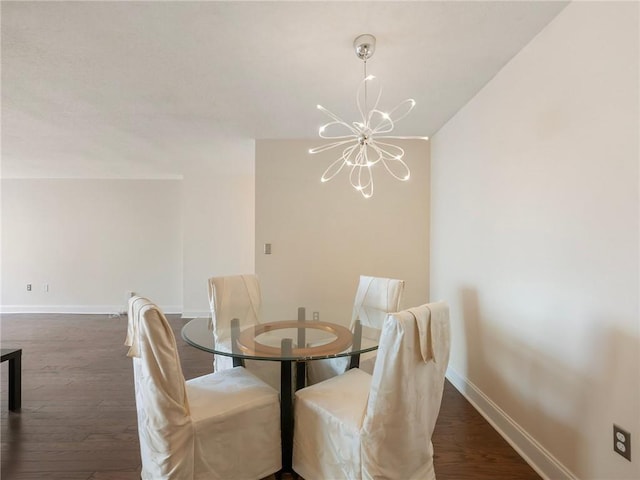 2479 Peachtree Rd NE Unit 407, Atlanta, GA 30305 - dining space featuring a chandelier, baseboards, and wood finished floors