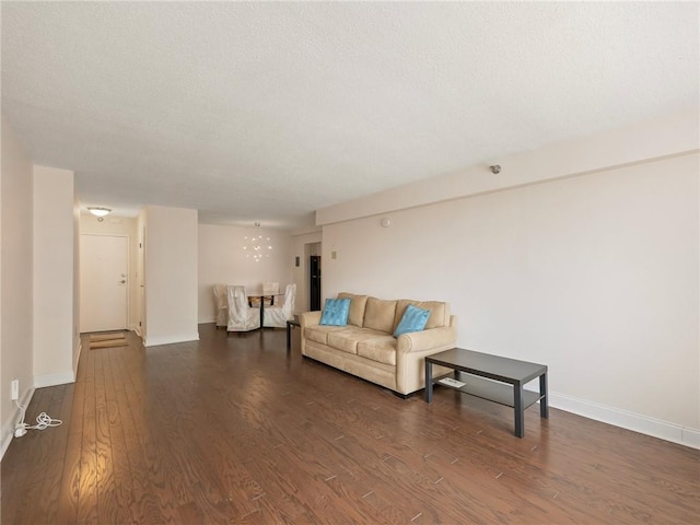 2479 Peachtree Rd NE Unit 407, Atlanta, GA 30305 - living room with wood finished floors, baseboards, a textured ceiling, and a chandelier
