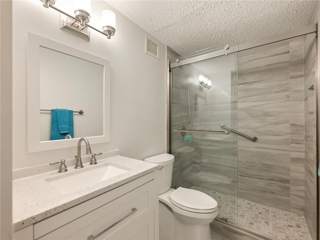 2479 Peachtree Rd NE Unit 407, Atlanta, GA 30305 - full bath featuring a textured ceiling, a stall shower, toilet, and vanity